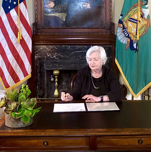 Secretary Janet Yellen signing currency