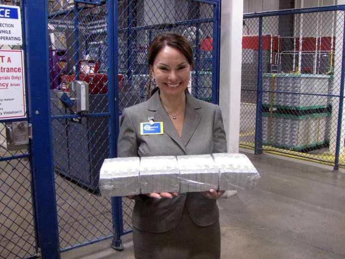 Treasurer of the United States Rosie Rios holds a brick containing $400,000 in $100 notes.