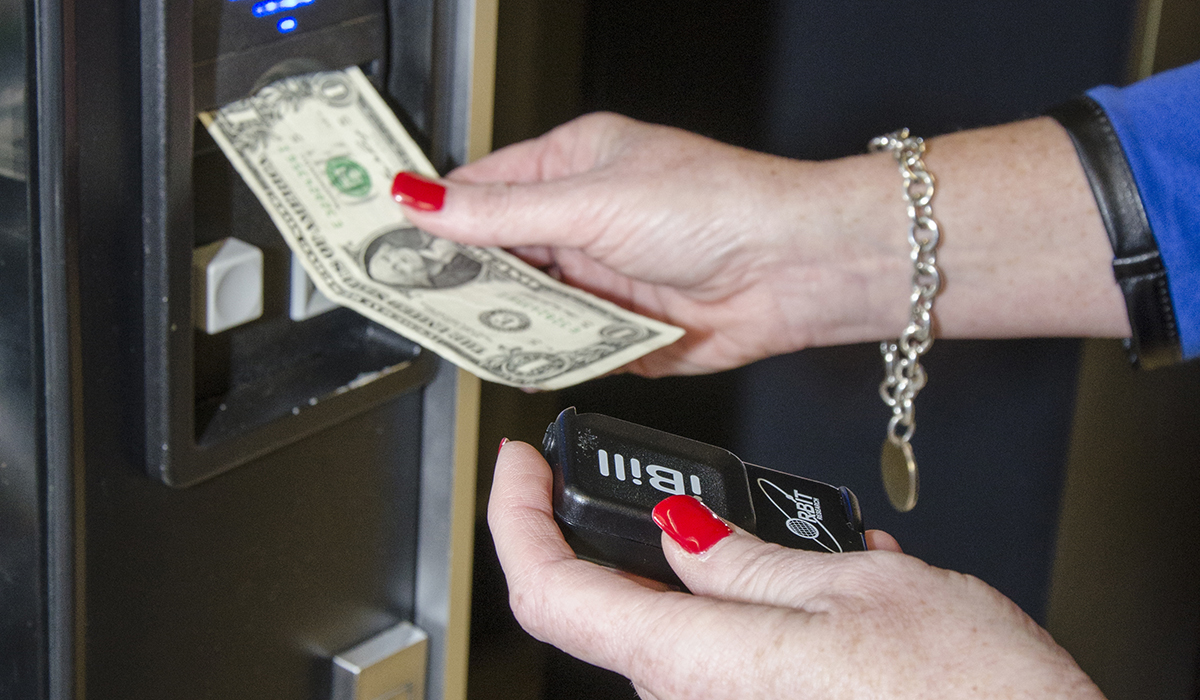 iBill currency reader with $1 bill in vending machine