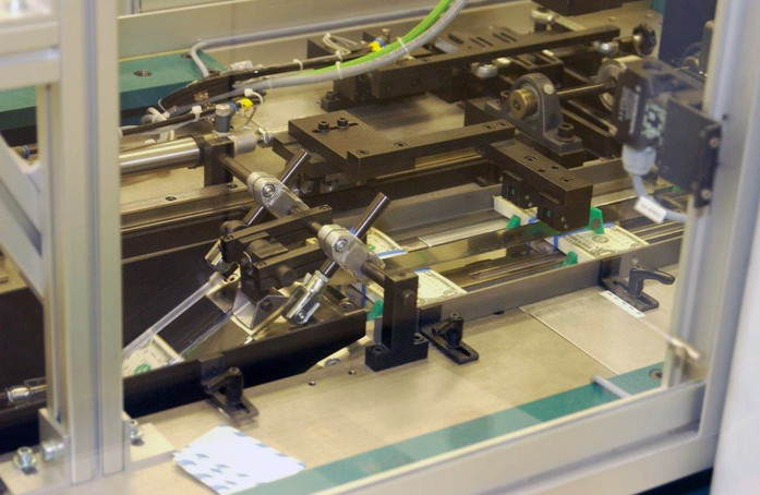 A unit of 100 $1 notes is banded before it is packaged.