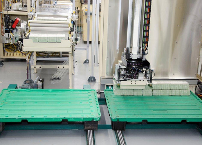 The Currency Overprinting and Processing Equipment's palletizer stacks 160 bricks onto a skid.