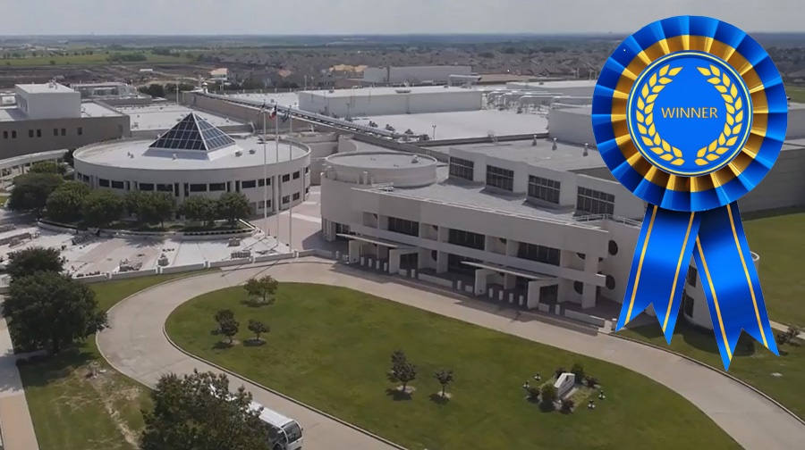 Aerial view of Western Currency Facility with blue "Winner" ribbon.